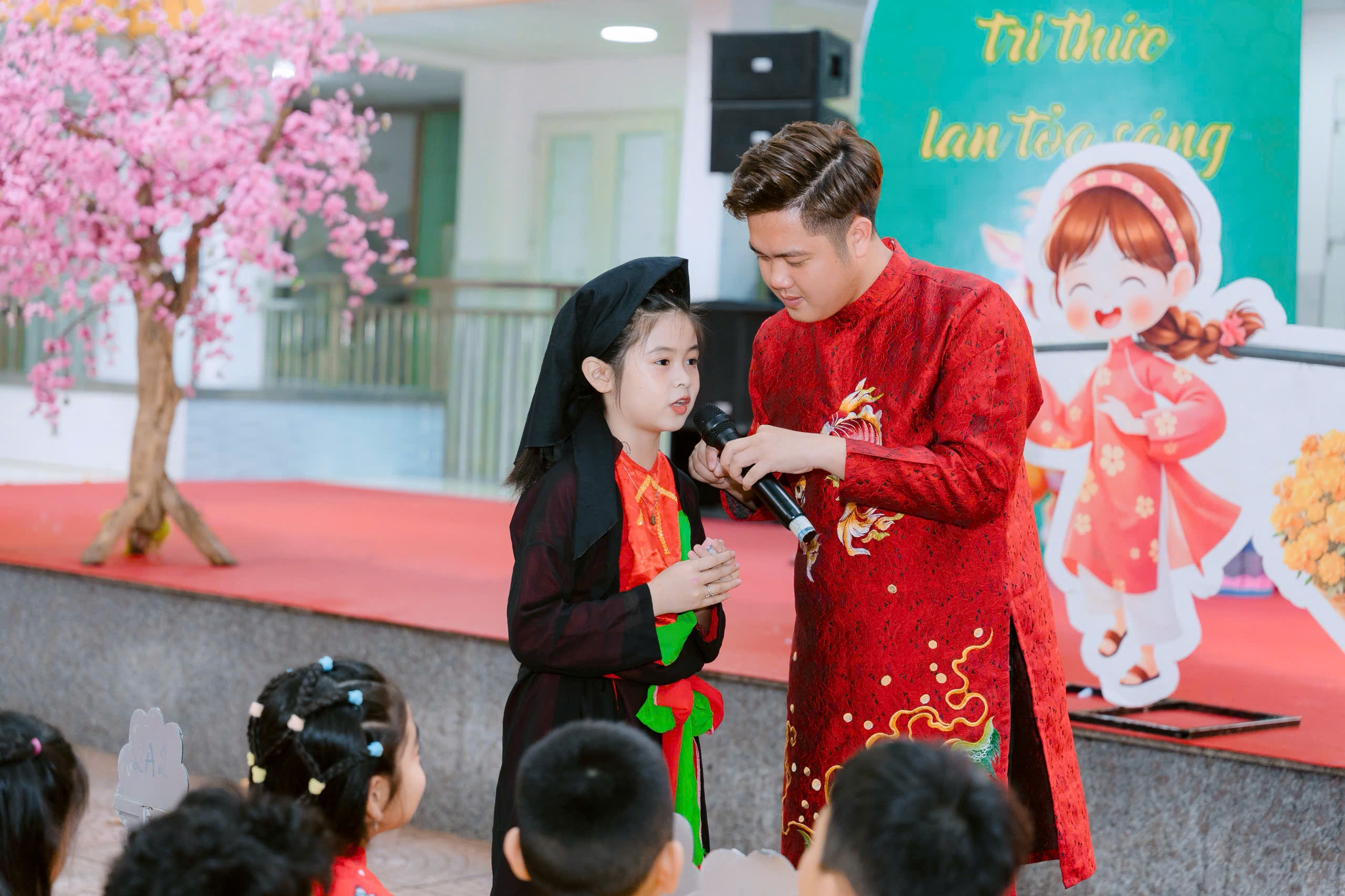 A person and a child holding a microphone
Description automatically generated