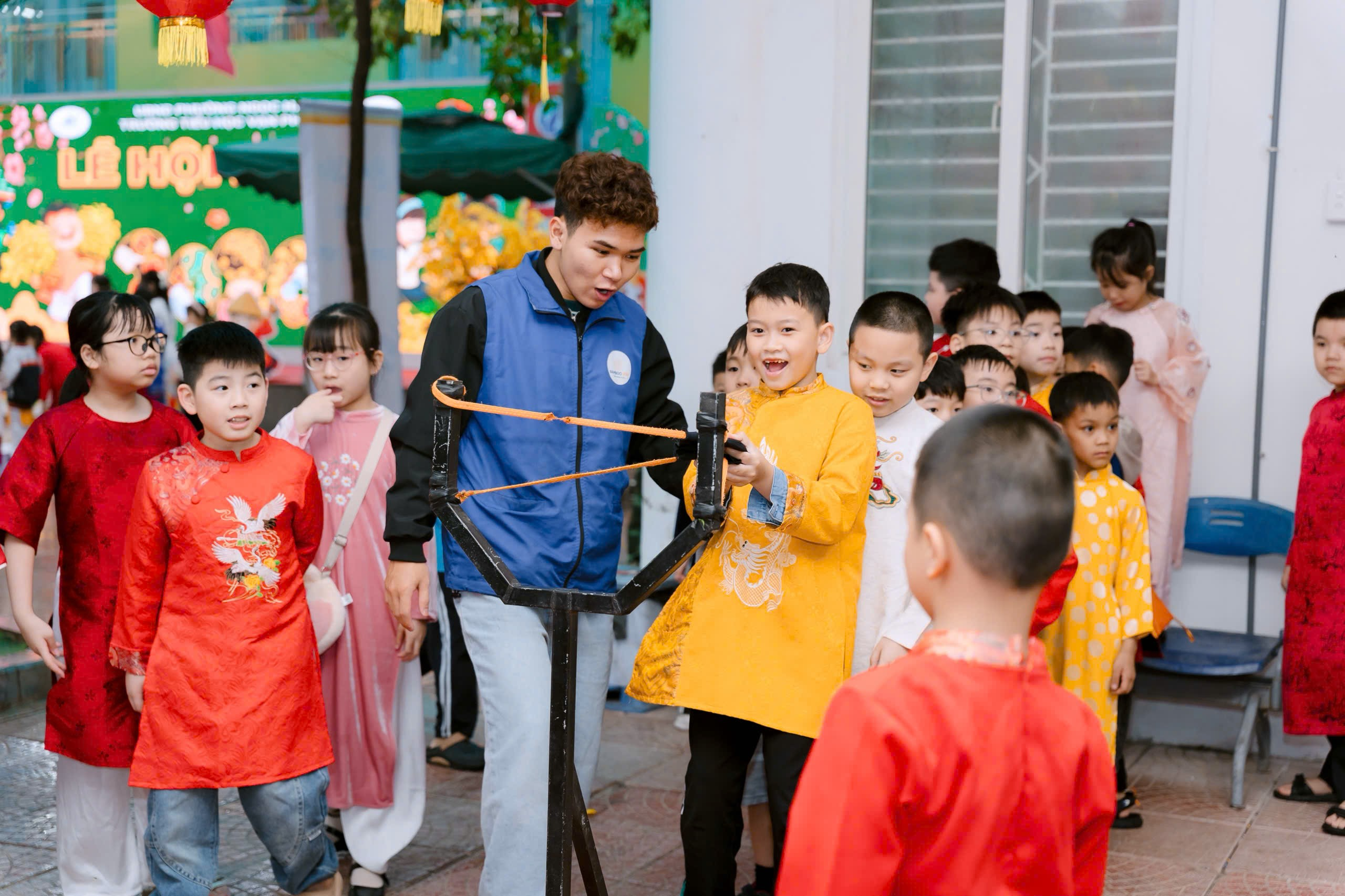 A group of children standing around a person holding a slingshot
Description automatically generated