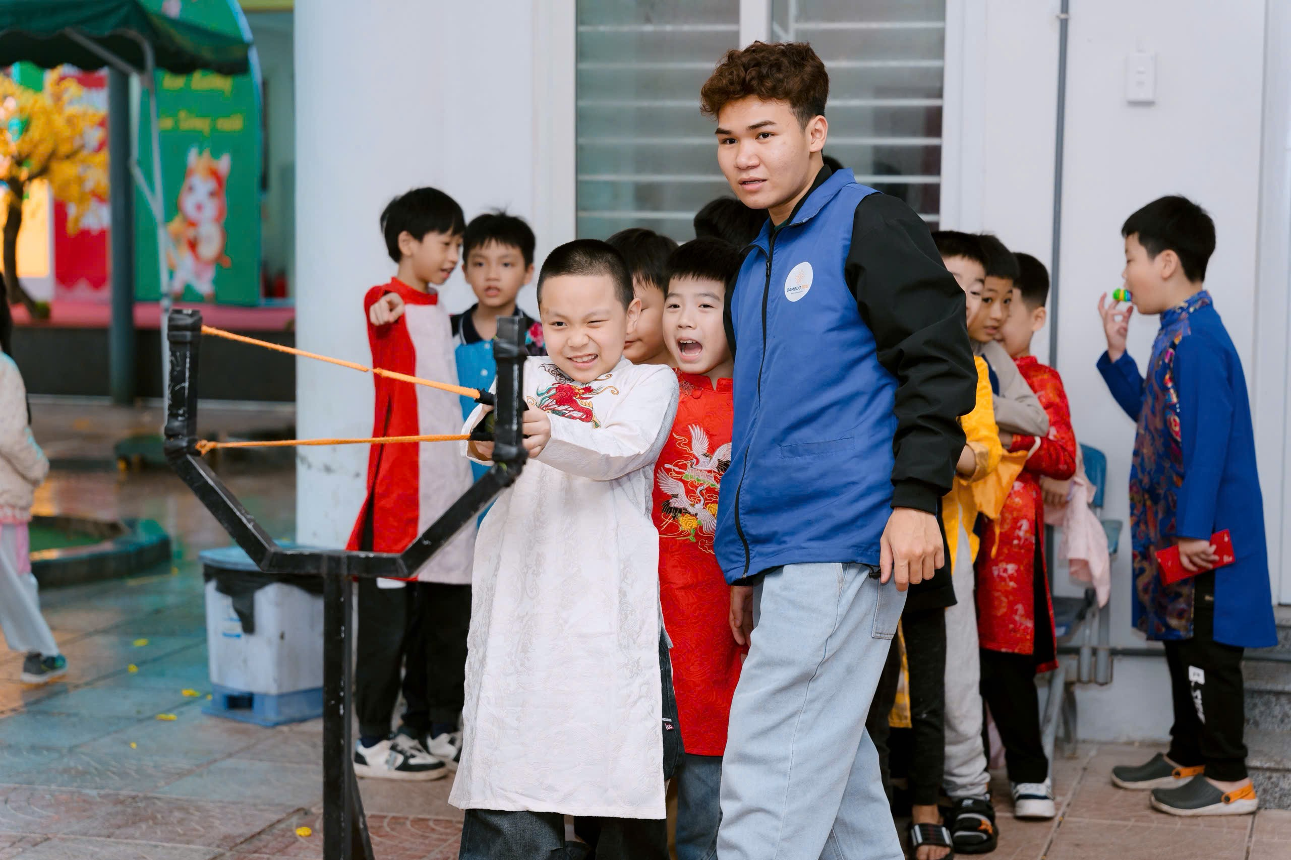 A group of kids playing with a toy object
Description automatically generated