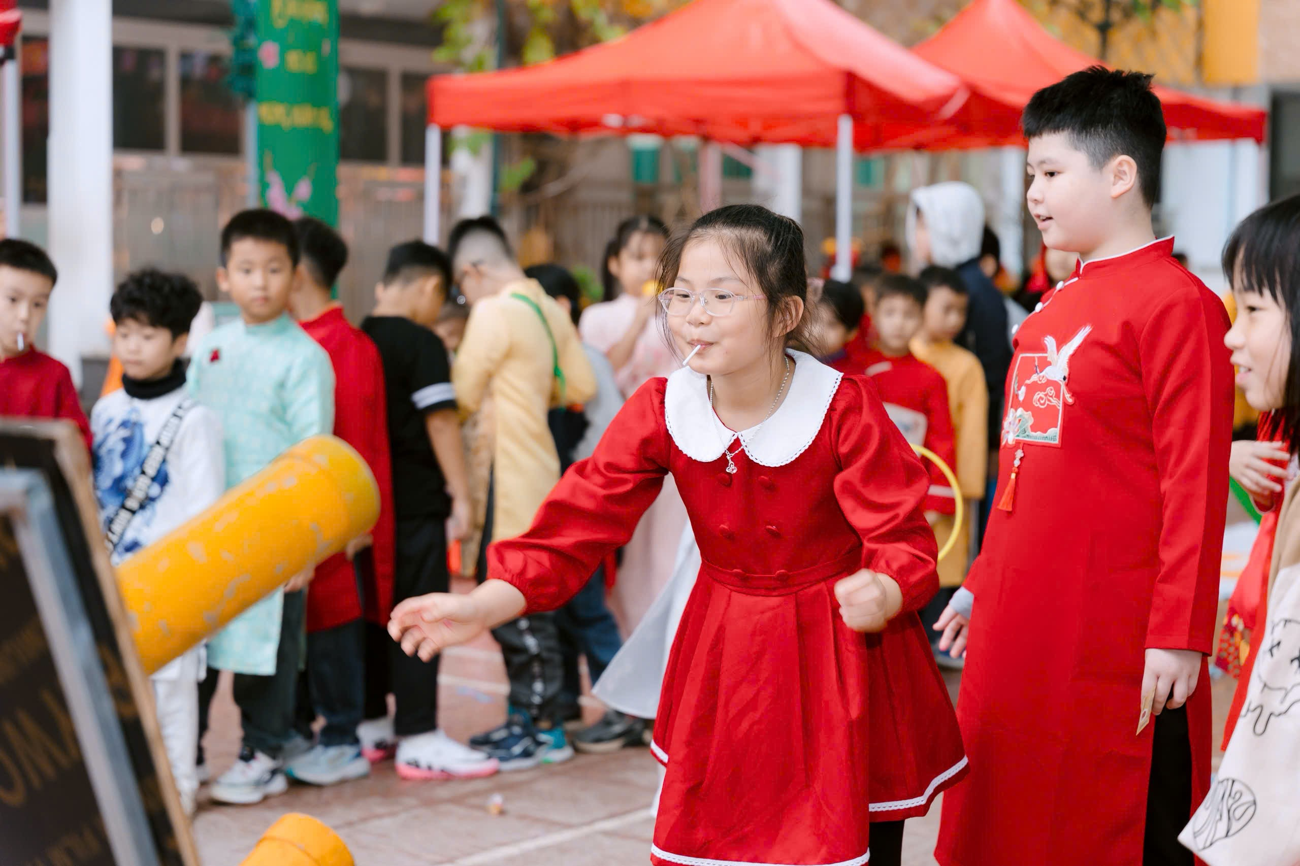A group of children in red dresses
Description automatically generated
