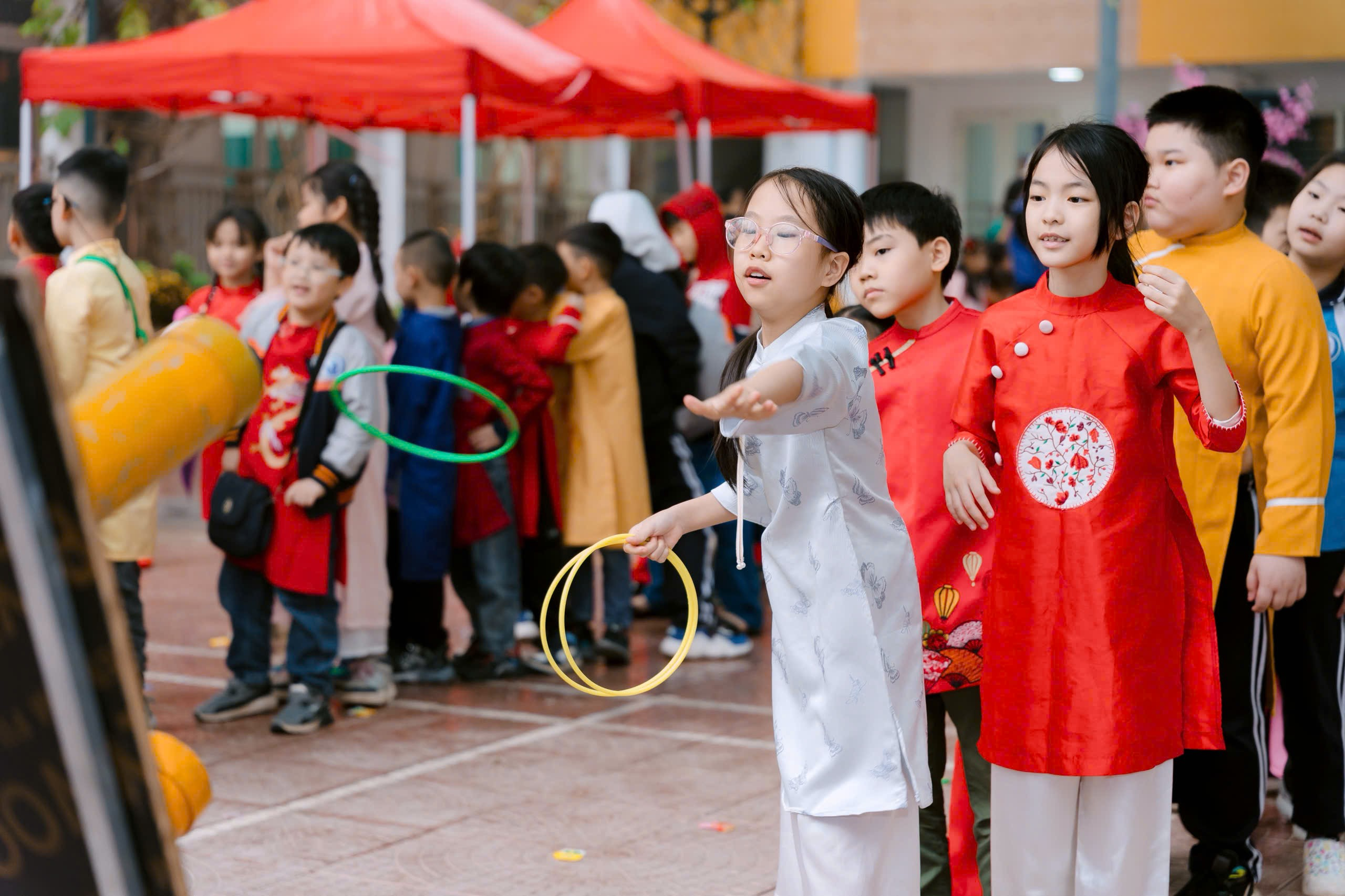 A group of children playing with hoops
Description automatically generated