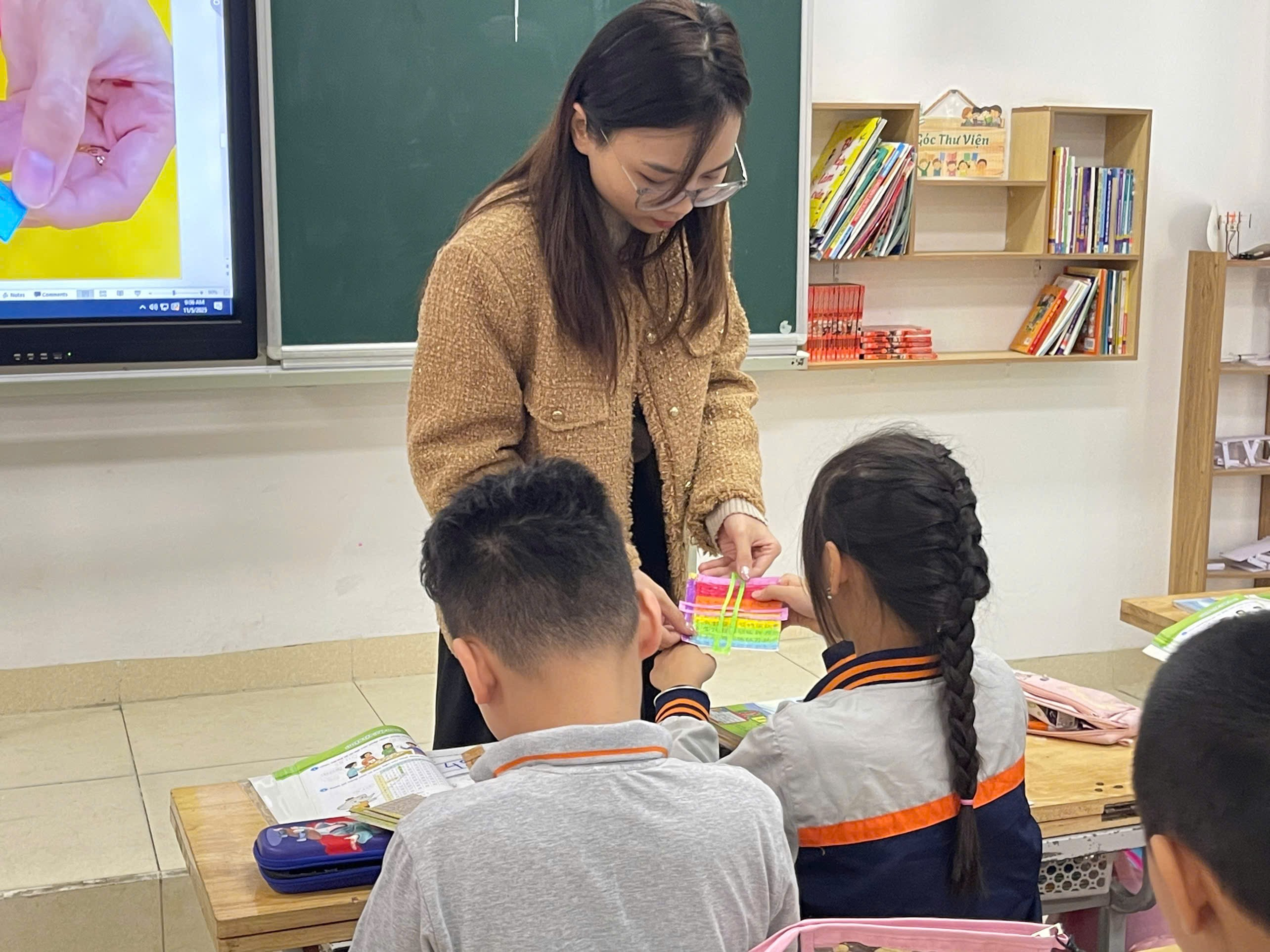 A person standing in front of a group of children

Description automatically generated