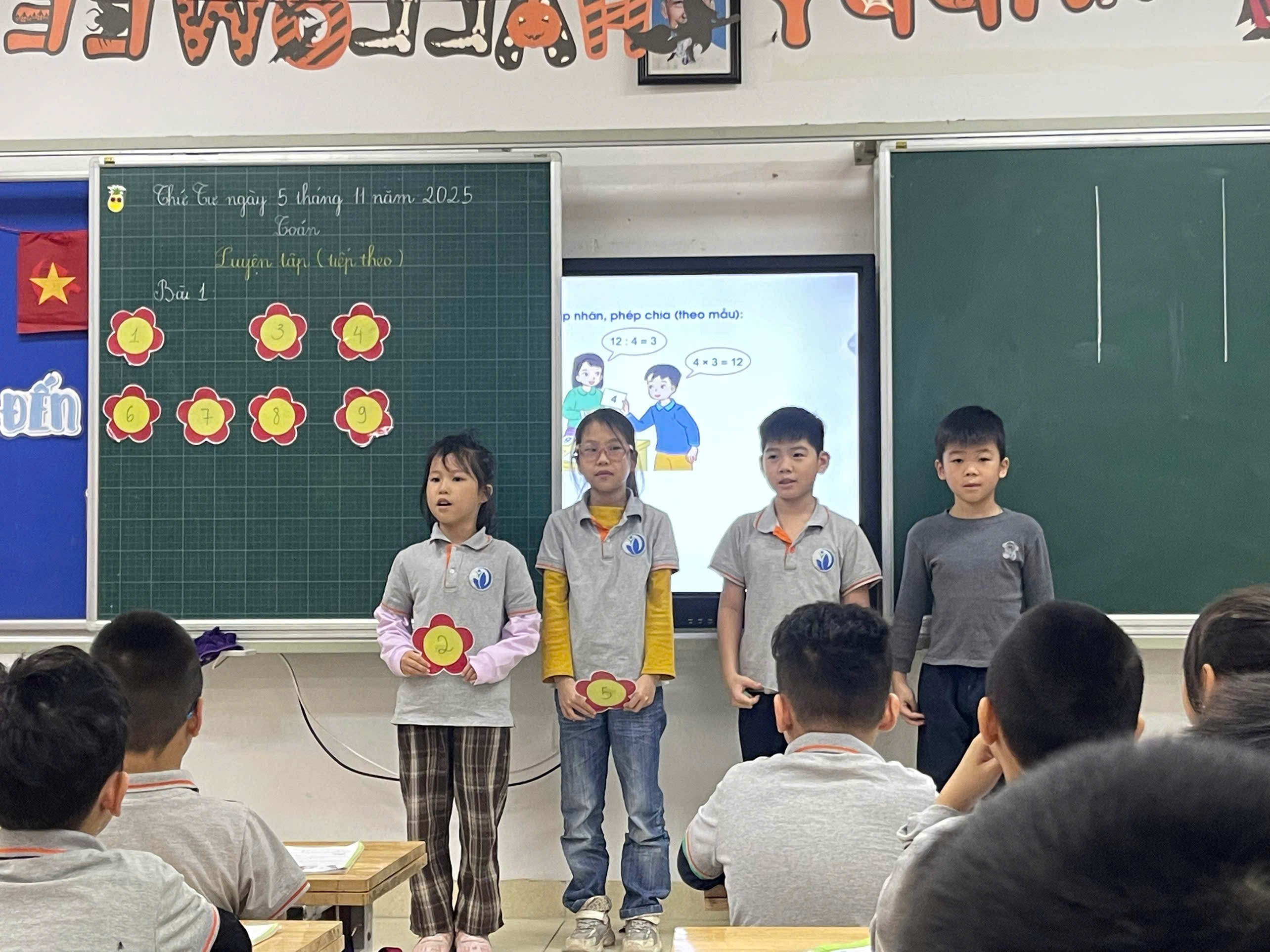 A group of children standing in front of a chalkboard

Description automatically generated